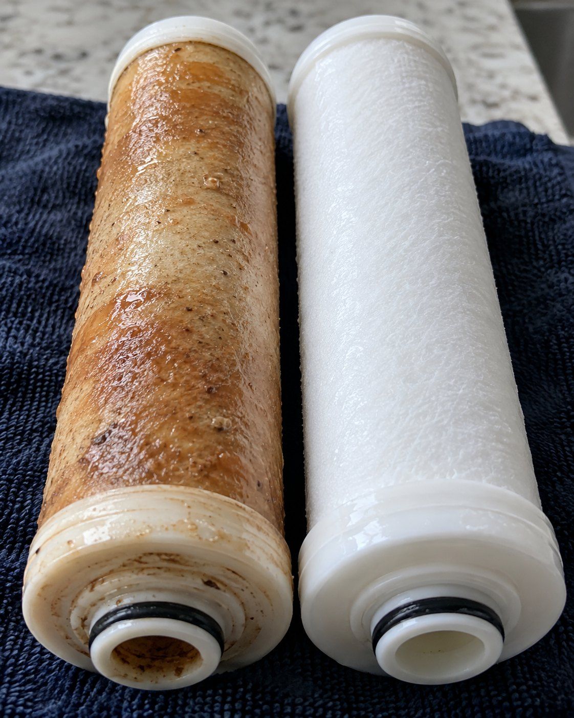 Refil de purificador saturado, amarelado de sedimento, ao lado de um refil novo